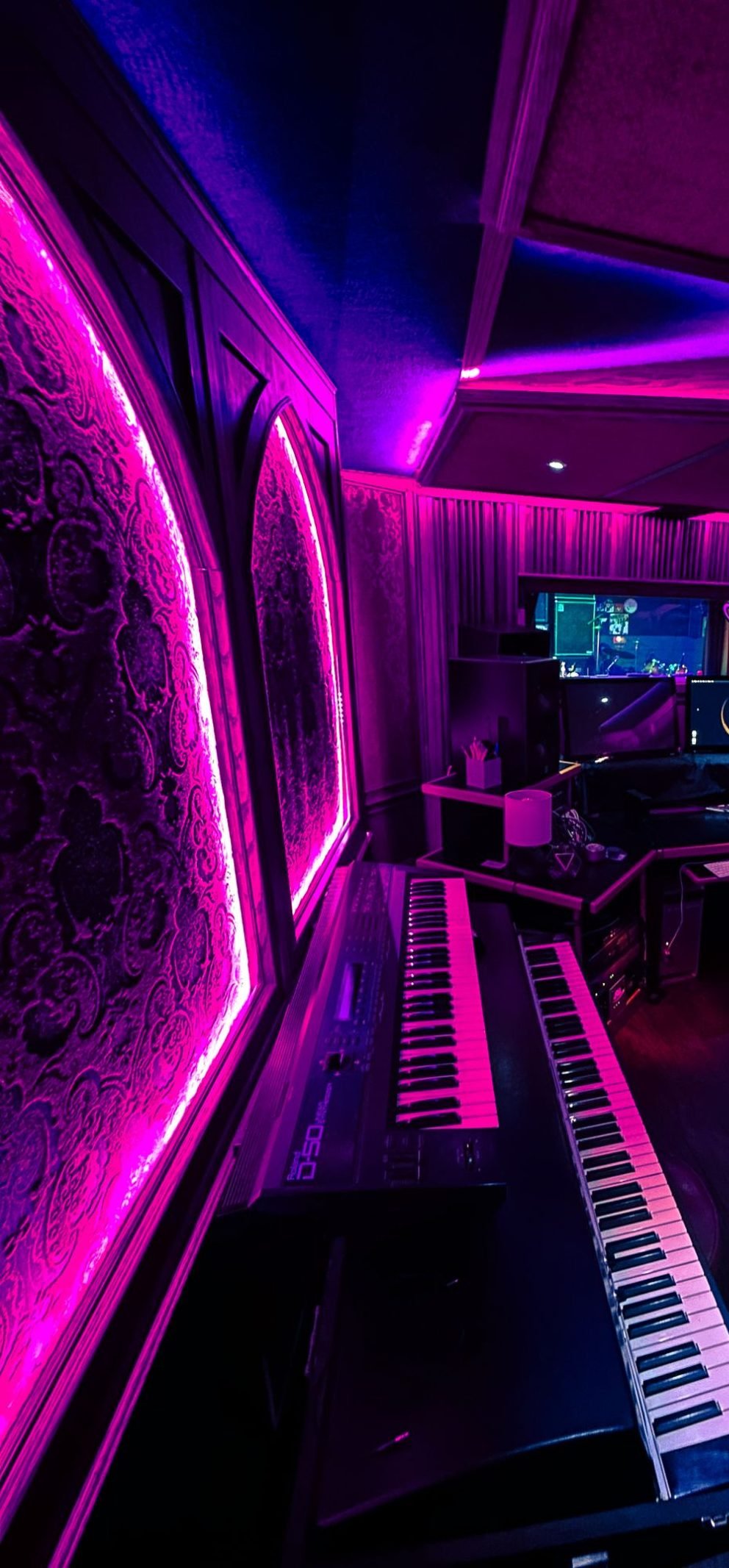 Inside the Black Lotus Recording control room, lit in pink and violet neon